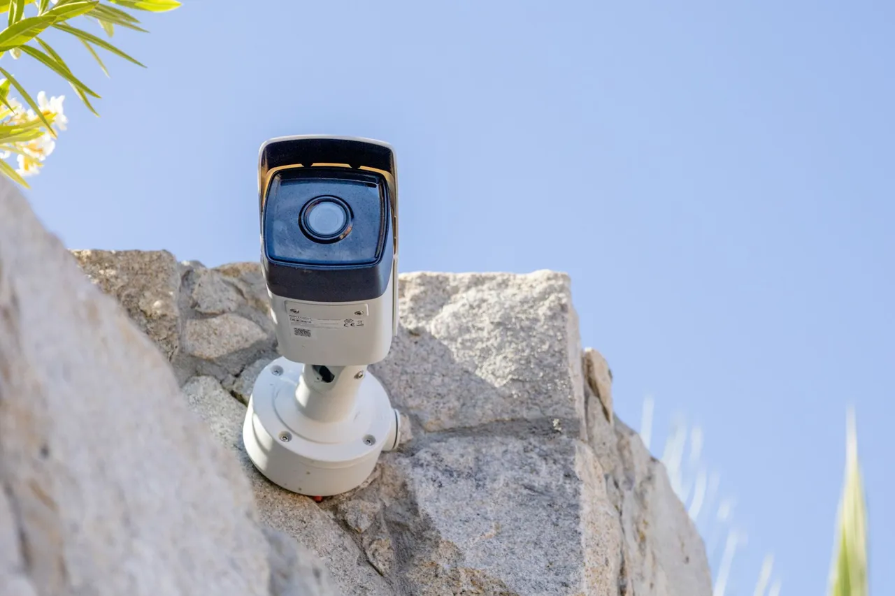 Close-up of a bullet camera on a granite wall