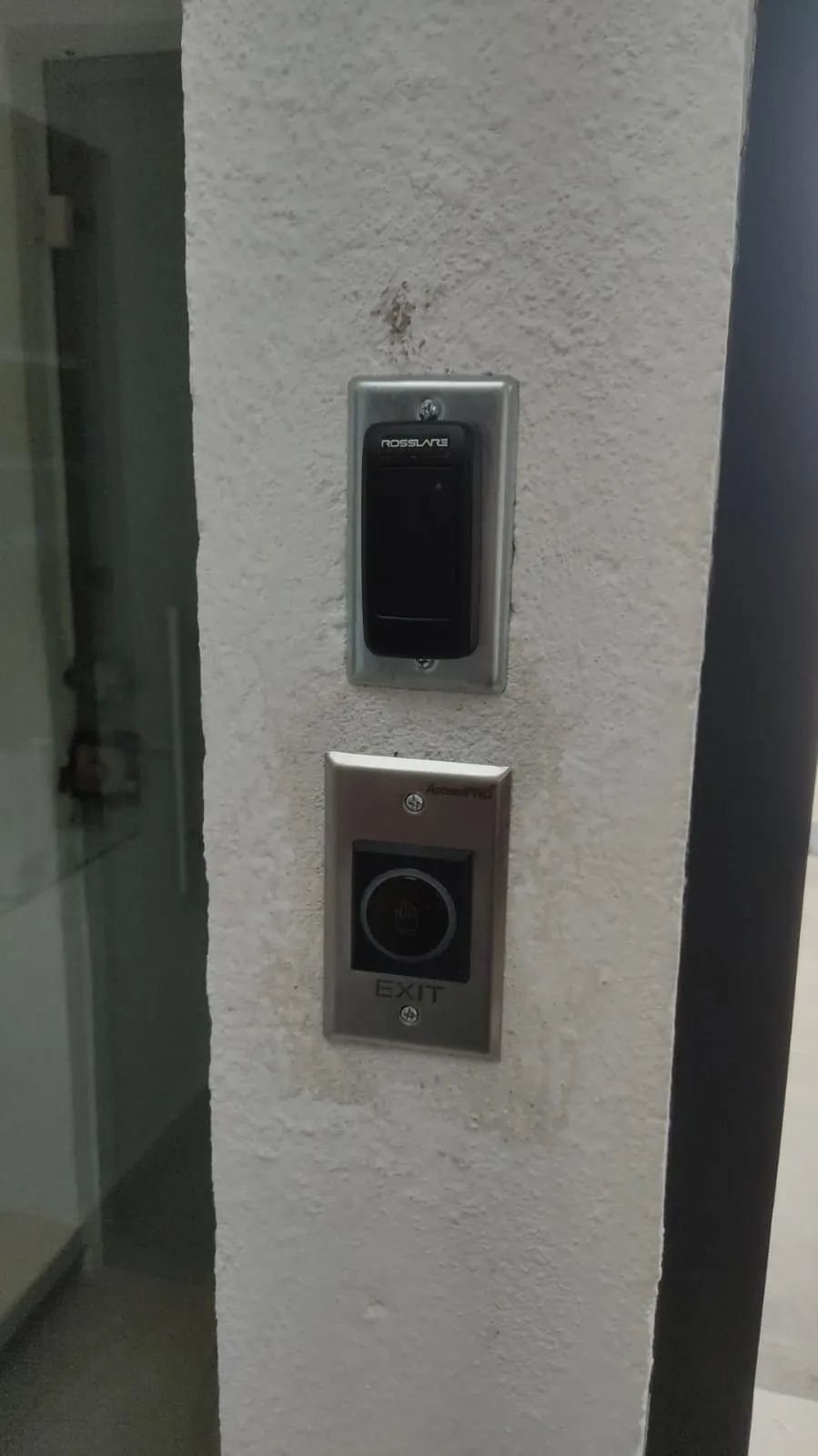 Card reader and exit button installed on a white column
