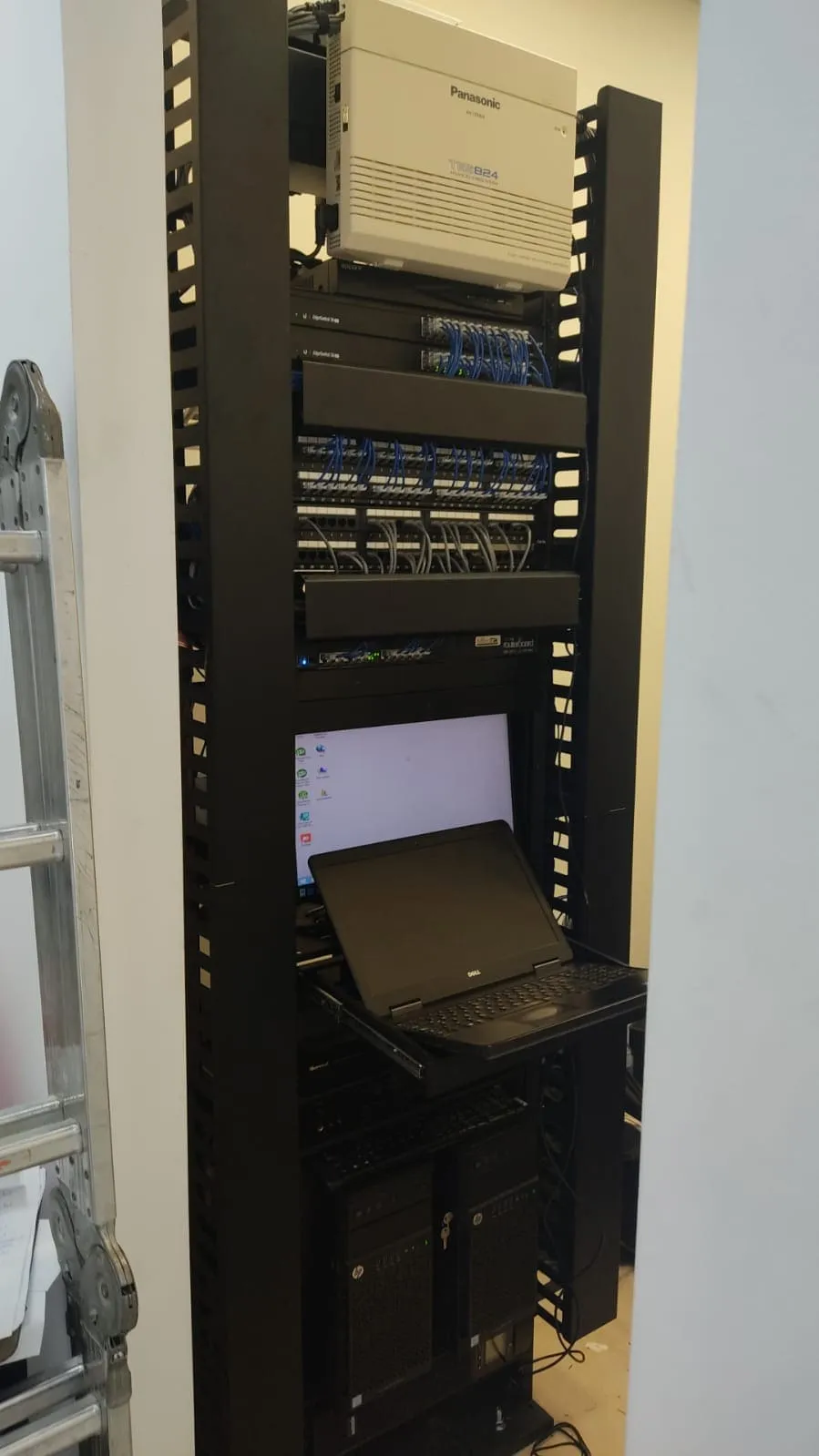 Rack with a phone system, switches and patch panels with tidy cabling