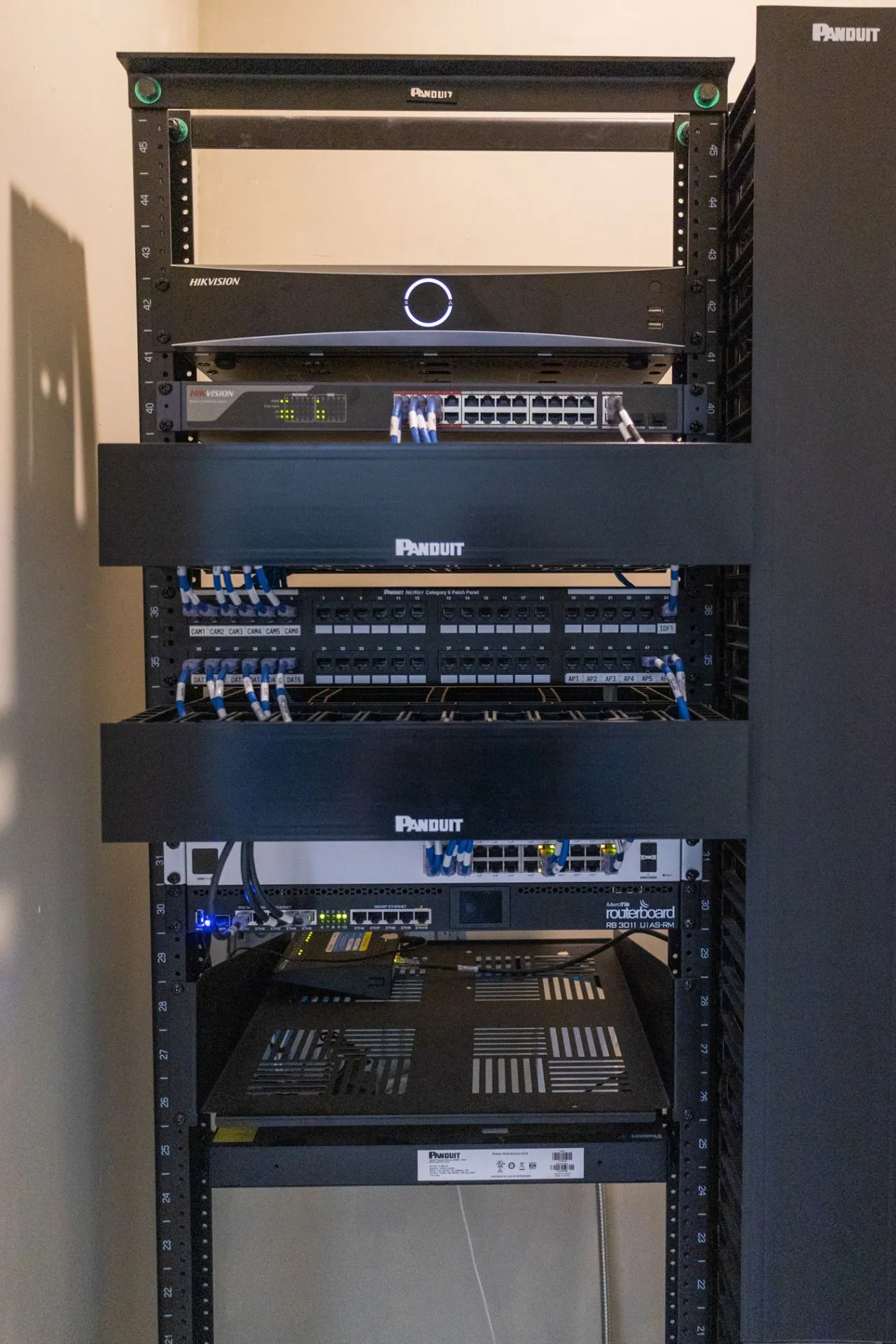 Communications rack with a video recorder, switches and a labeled patch panel