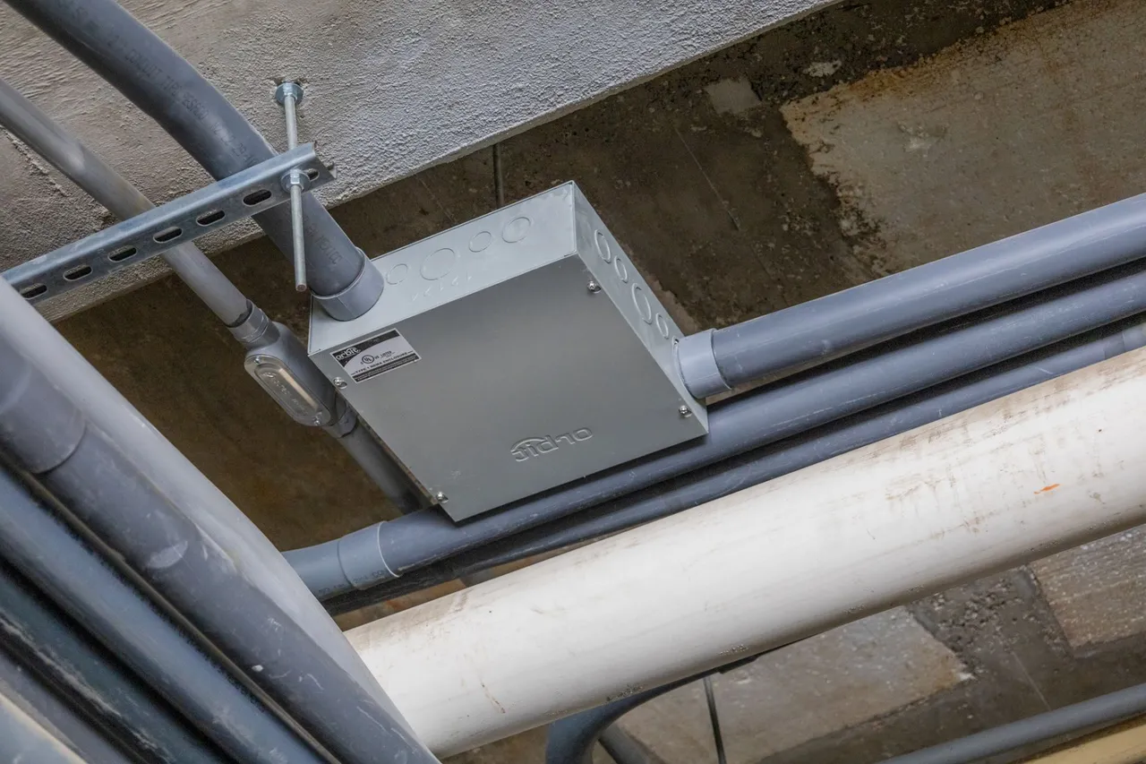 Junction box and PVC conduit under a concrete ceiling